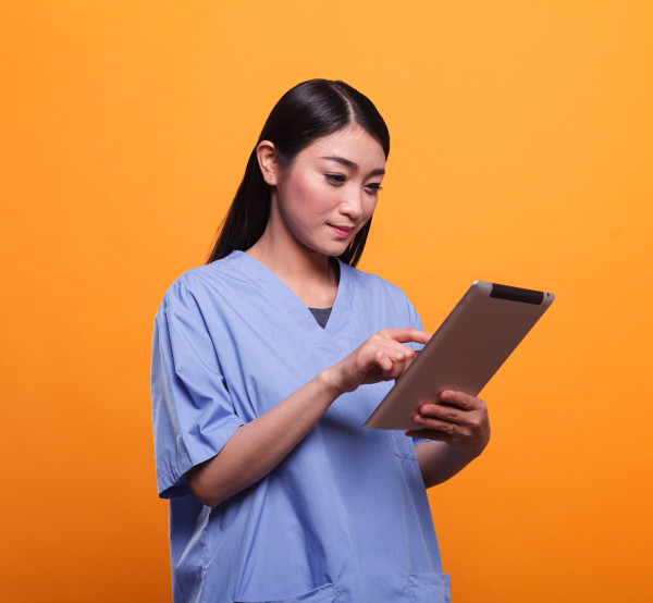 nurse orange background with tablet